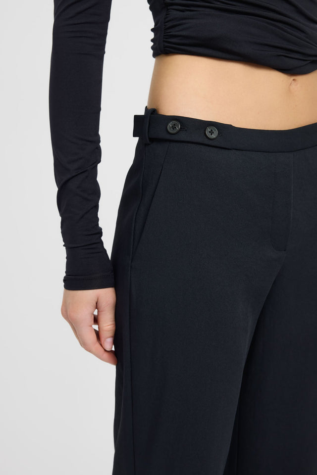 Featuring the Ariel Button Tab Pant in wide-leg high-rise black womens regular pants detail