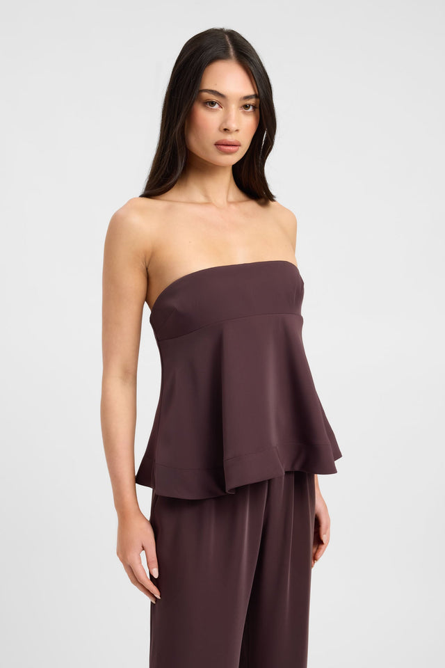 Showcasing the Maria Peplum Top womens-blouse in maroon with solid fitted straight neckline sleeveless detail