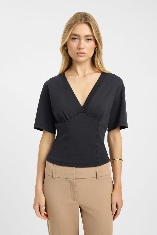 Featuring the Levi Tee womens blouse with fitted black v-neck design and short sleeves front