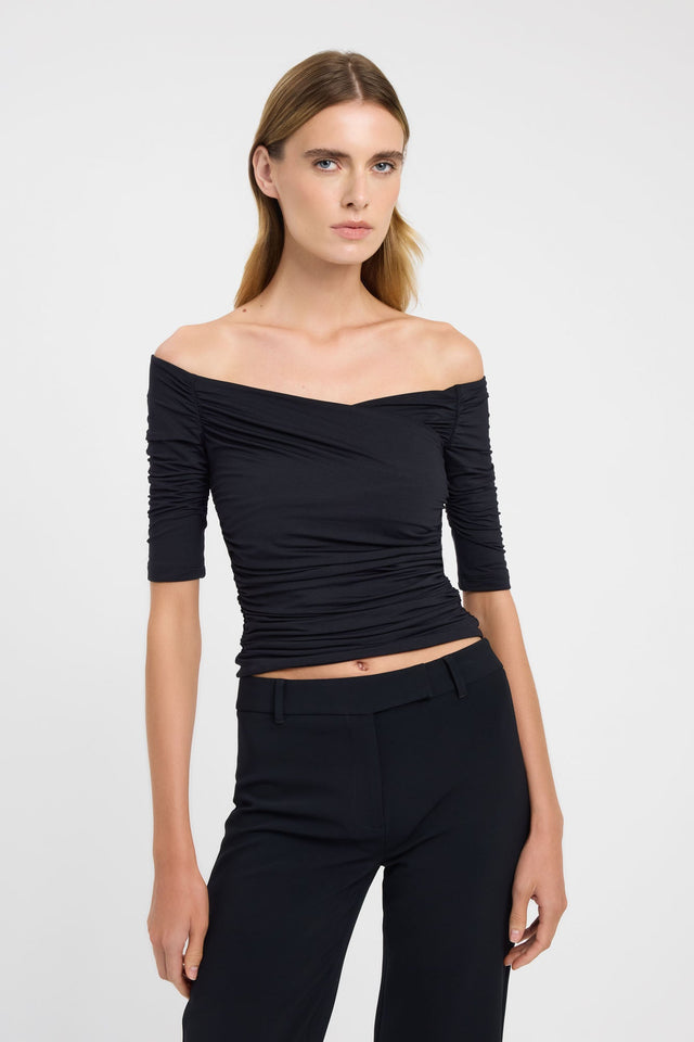 Featuring the Drew Top womens blouse in black with fitted straight neckline and half sleeves front
